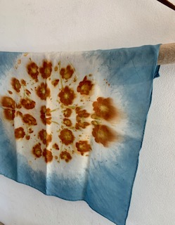 A hand-printed indigo cloth scattered with yellow marigold flower prints