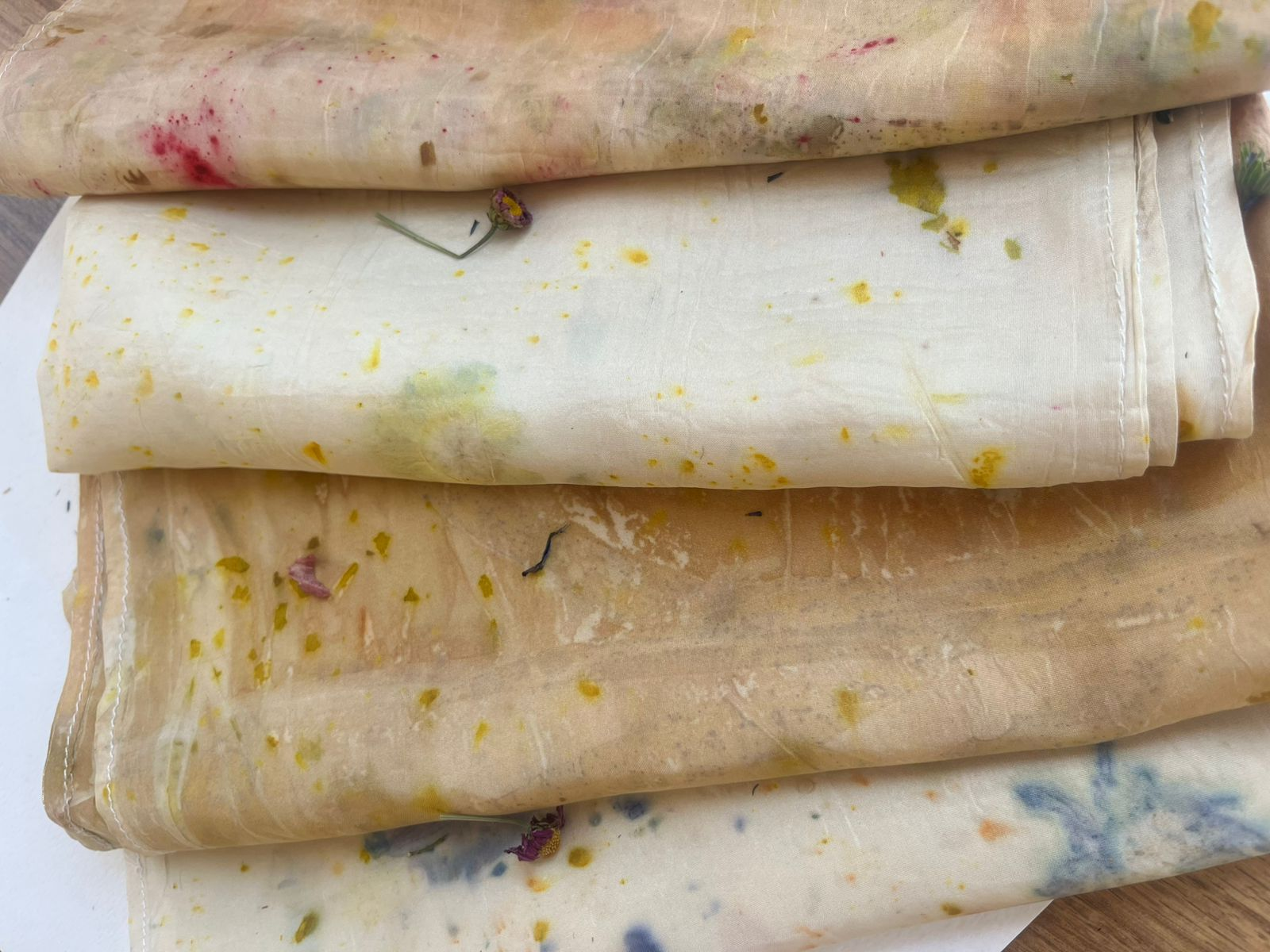 Light summer botanical prints on folded silk cloth with fresh flower details