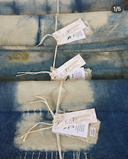 Indigo-dyed botanical textiles with hand-written KAIA tags tied in bundles