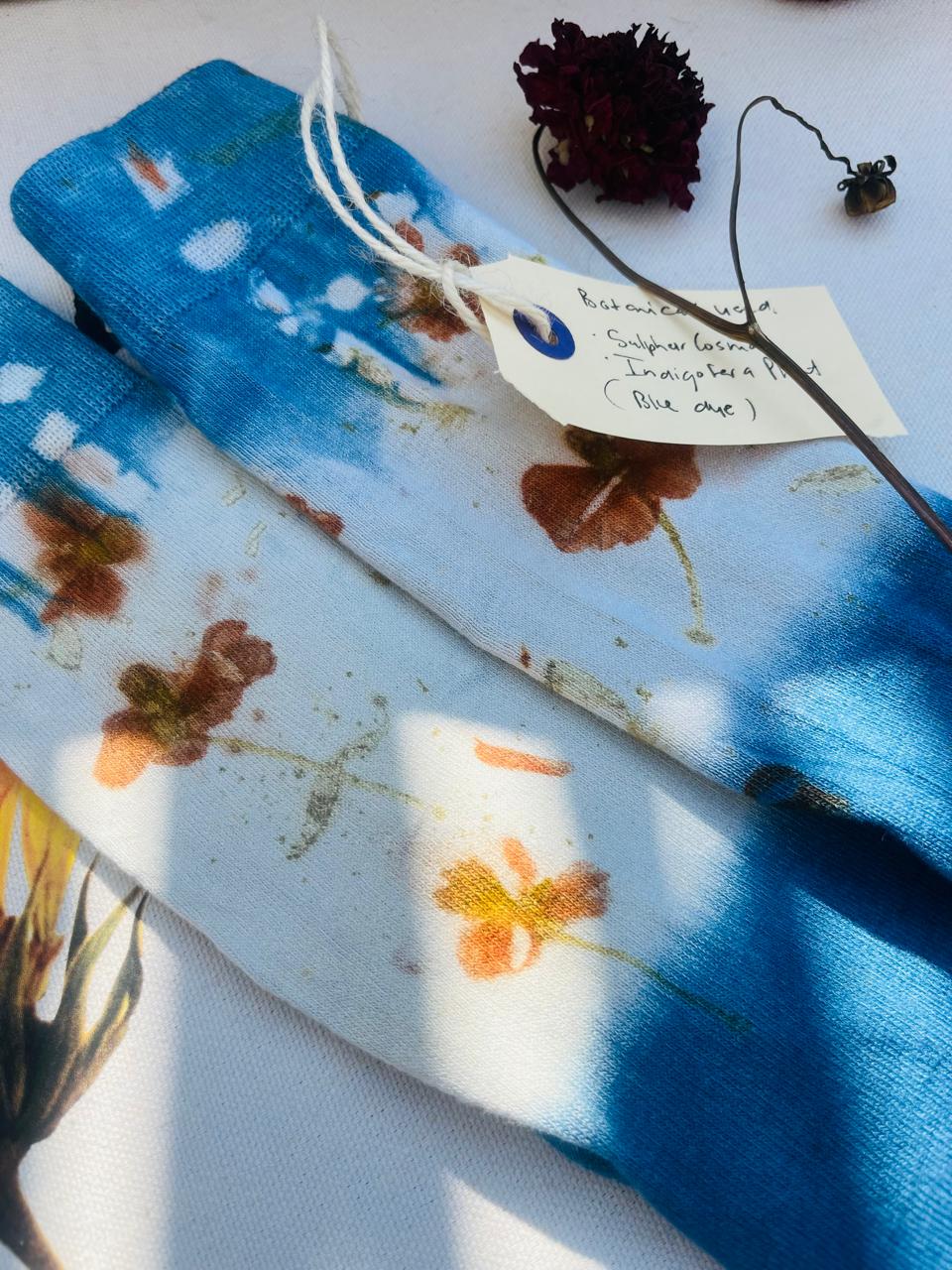 Indigo and botanical printed cloth with a handwritten KAIA tag