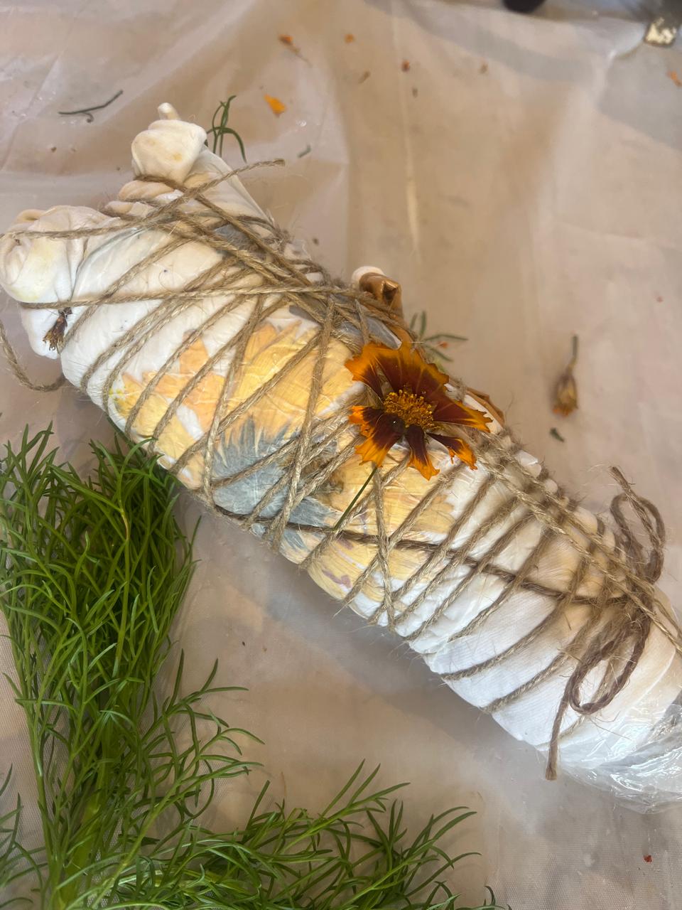 A botanical textile bundle wrapped tightly with natural twine