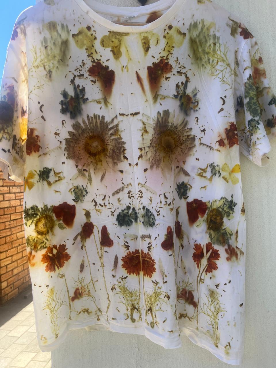 The finished botanical printed T-shirt hanging in the sun